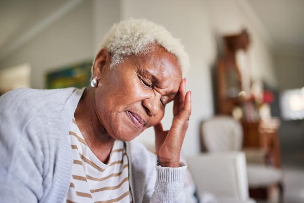 Elderly black woman experiencing concussion symptoms
